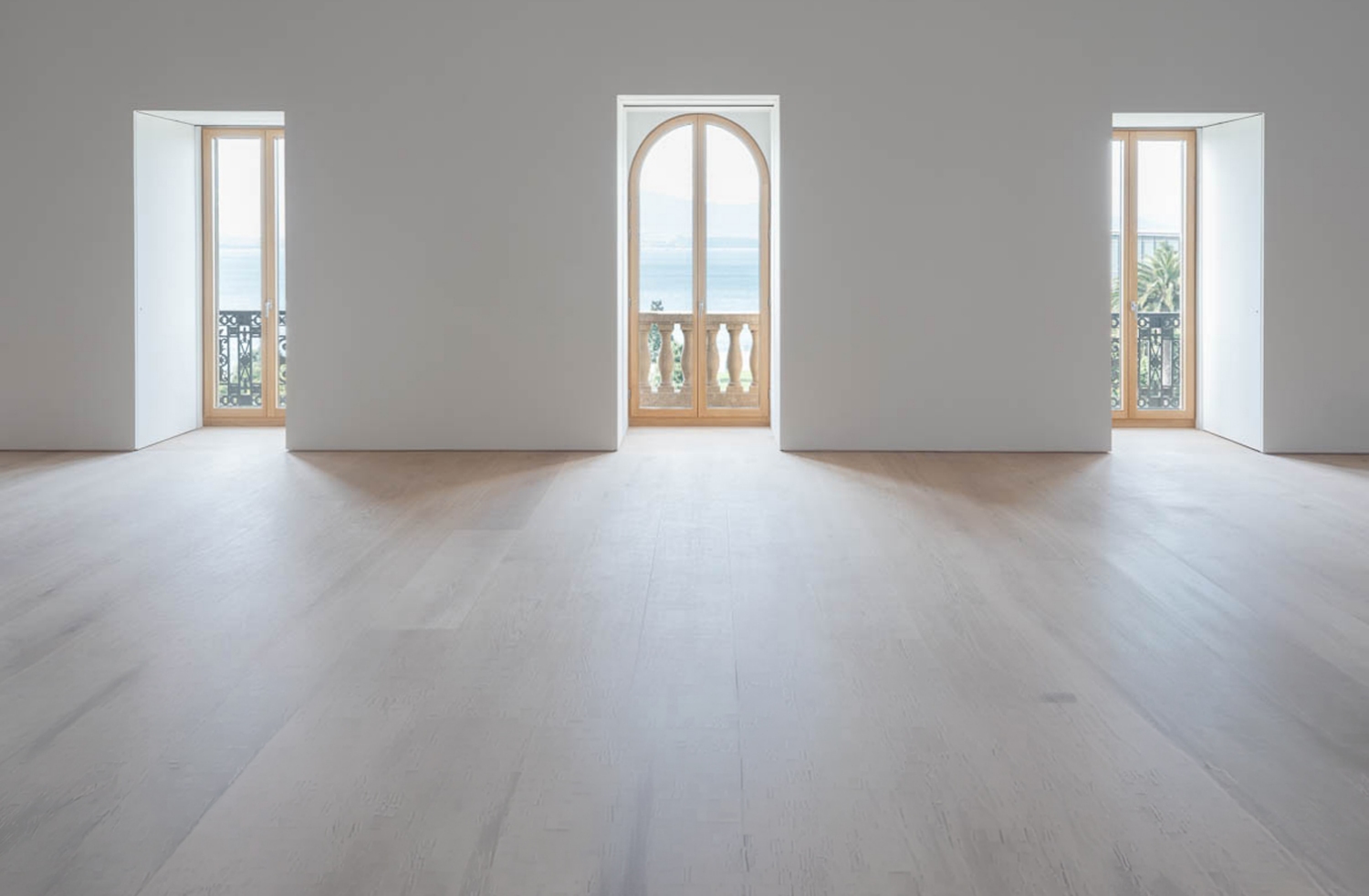 Ventanales con balustrada y vistas a la bahía en la sala de exposiciones del Edificio Pereda de Faro Santander.